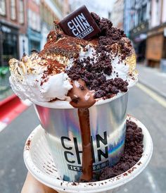 someone holding up a giant ice cream sundae