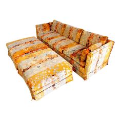 an orange couch and ottoman sitting next to each other on a white background with no one in it