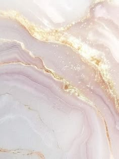 an abstract marble background with gold and pink colors, like paint on paper or fabric