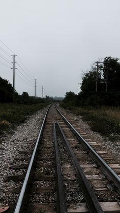 an empty train track in the middle of nowhere