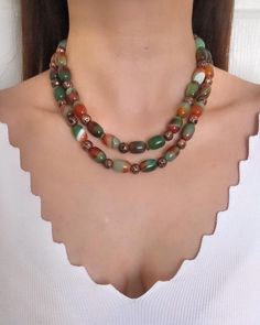 Agate and Lava Stone Multistrand Beaded Necklace ✅ NECKLACE FEATURES * Handmade Item: Each necklace is meticulously crafted by hand, ensuring quality and uniqueness. * Materials: patterned green and brown natural agate stone, brown lava stone, gold plated details and chain * Length: 43 cm (17 inches) + 5 cm (2 inches) adjustment chain.    -If you require a longer extension chain, please let me know. * Color Discrepancies: Please be aware that color variations may occur due to different monitor settings. * Natural Stone Variations: Natural stones may vary slightly in size, shape, and color tones due to their unique characteristics. These small differences make your jewelry special and one-of-a-kind. ⭐️ This elegant necklace features tube-shaped agate stones in green and brown tones, along w Agate Beaded Necklaces For Jewelry Making, Agate Necklaces With Natural Stones, Earthy Multicolor Beaded Necklaces With Natural Stones, Earthy Multicolor Gemstone Beaded Necklaces, Multicolor Agate Large Beaded Necklaces, Multicolor Agate Necklaces With Large Beads, Multicolor Agate Beaded Necklace With Large Beads, Multicolor Large Beads Agate Necklace, Healing Gemstone Beaded Necklaces