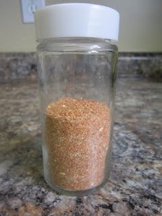 a glass jar filled with sand sitting on top of a counter