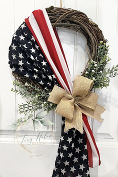 an american flag wreath hanging on the front door