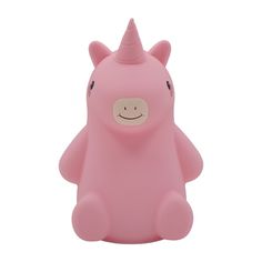 a pink toy with a smiling face on it's head and arms, sitting in front of a white background