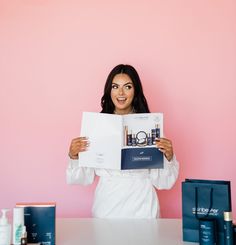 a woman holding up a book in front of her face