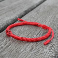 Adjustable bracelet Cotton Cord Red Spiritual Bracelets For Friendship, Red Casual Wristband As Gift, Casual Red Wristband As Gift, Casual Red Wristband For Gift, Casual Red Jewelry With Sliding Knot, Casual Red Round Stretch Bracelet, Red Bangle Friendship Bracelets, Red Resizable Bracelet, Red Bangle For Friendship