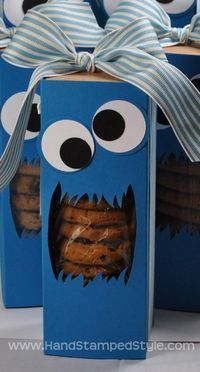 some cookies are in a box with googly eyes and mouth on it's side