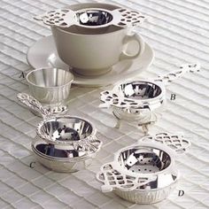 a white table topped with silver dishes and cups