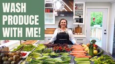 a woman standing in front of a table full of vegetables and fruits with the words wash produce with me