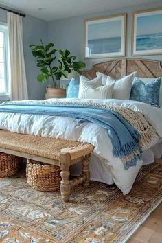 a bedroom with a large bed and two wicker baskets on the footboard next to it