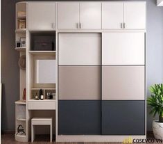 a white and grey closet with shelves next to a potted plant