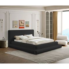 a large bed sitting on top of a wooden floor