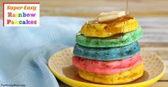 a stack of rainbow donuts sitting on top of a yellow plate