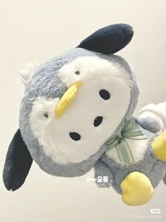 a stuffed penguin is hanging from the ceiling with it's nose open and eyes closed