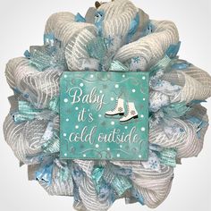 a wreath that says baby it's cold outside with an image of a pair of shoes