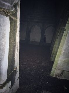 a dark hallway in an abandoned building