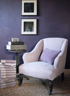 a chair and table in a room with purple walls