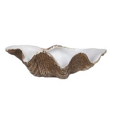 a brown and white bowl sitting on top of a table