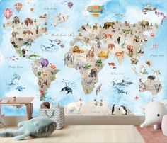 a child's room with a large wall mural featuring animals on the world map