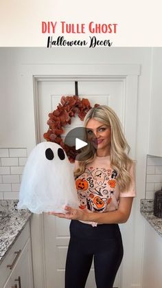 a woman holding a white ghost pillow in her hands with the words diy tulle ghost on it