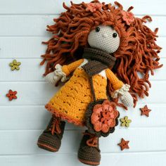 there is a crocheted doll with long hair and boots on it's head