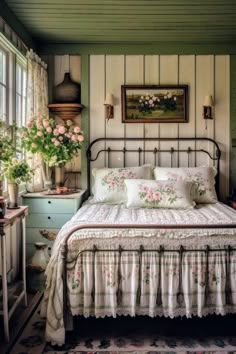 a bed sitting in a bedroom next to a window with flowers on the headboard