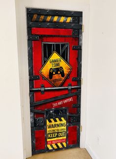 a door with a warning sign on it and a video game controller in the middle