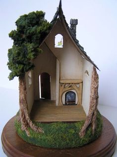 a miniature house with trees on the outside