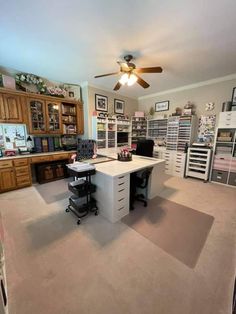 a home office with two desks and lots of drawers