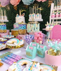 a table filled with lots of colorful desserts and candy bar decorations on top of it