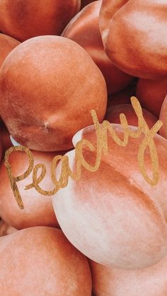 a pile of doughnuts with the word fresh spelled in gold foil on top