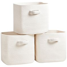 three white storage baskets stacked on top of each other with handles and two large ones