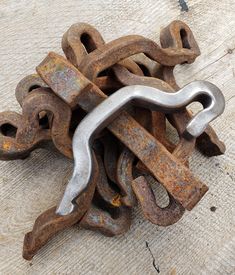 an old rusted metal chain on the ground