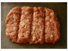 four pieces of meat sitting on top of a pan