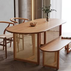 a wooden table with two chairs and a vase on it