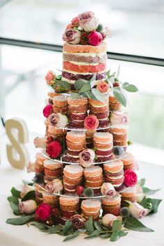 a wedding cake made out of cupcakes and flowers