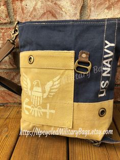 "US Navy Crossbody | Shoulder Bag is Strong, Proud and Patriotic. Our US Navy Crossbody | Shoulder Bag is UpCycled, from re-purposed military canvas, tents & tarps. Perfect Size, durable and ready to report for duty! Navy Strong: Navy Wife and Navy Mom or Navy YOU! ZIP TOP CLOSURE 10.5\" x 10.5\" ---------SIZE MATTERS! Please check out the dims! FRONT POCKET BACK ZIPPED POCKET FULLY LINED 1 ZIPPED INSIDE POCKET 2 INSIDE POCKETS ADJUSTABLE STRAP You can check out all of our crossbody options Canvas Tents, Navy Purse, Street Style Bags, Navy Bag, Tent Tarp, Real Leather Bags, Canvas Purse