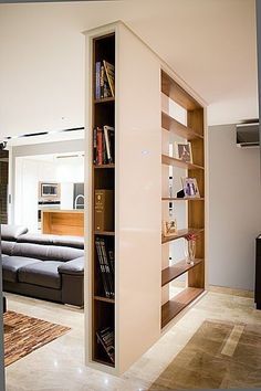 an open book shelf in the middle of a living room