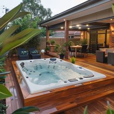 a hot tub sitting on top of a wooden deck