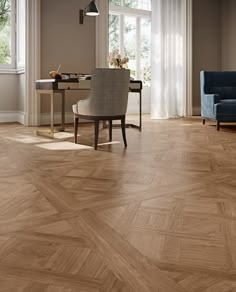 a living room filled with furniture and a wooden floor covered in hard wood planks