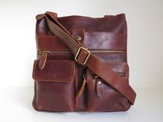 A neat and stylish cross body messenger style bag made from thick antique finish leather that ages beautifully. The front pockets make this bag Multi Pocket Bag, Red Leather Bag, Bags Leather Handbags, Women's Bags By Style, Brown Leather Handbags, Sack Bag, Top Handle Handbags, Brown Vintage