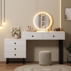 a white vanity with a round mirror and lights on it's side, next to a plant