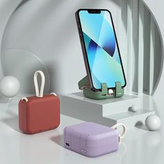 an image of a cell phone charging on a stand next to other devices and accessories