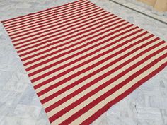 a red and white striped rug on the floor