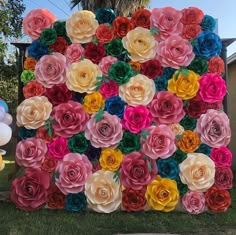 large paper flowers arranged in the shape of a square frame on display at a birthday party