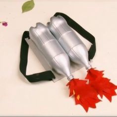 two silver metal objects with red leaves attached to them