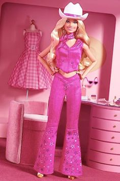 the barbie doll is wearing a pink outfit and cowboy hat with her hands on her hips