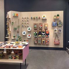 there is a display in the store with many items on shelves and plates hanging from the wall