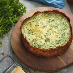 someone is holding a piece of quiche on a plate