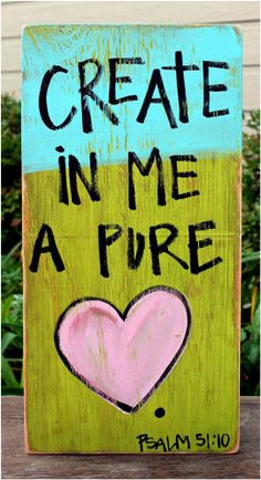 a sign that says create in me a pure with a pink heart on the front